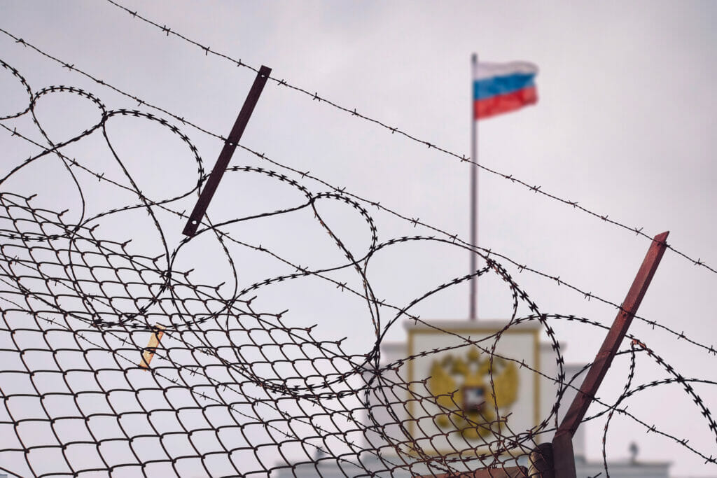 The concept of European and US sanctions pressure on the Russian Federation government. flag of the Russian Federation in barbed wire, sanctions and aggression of Russia. Russian prison