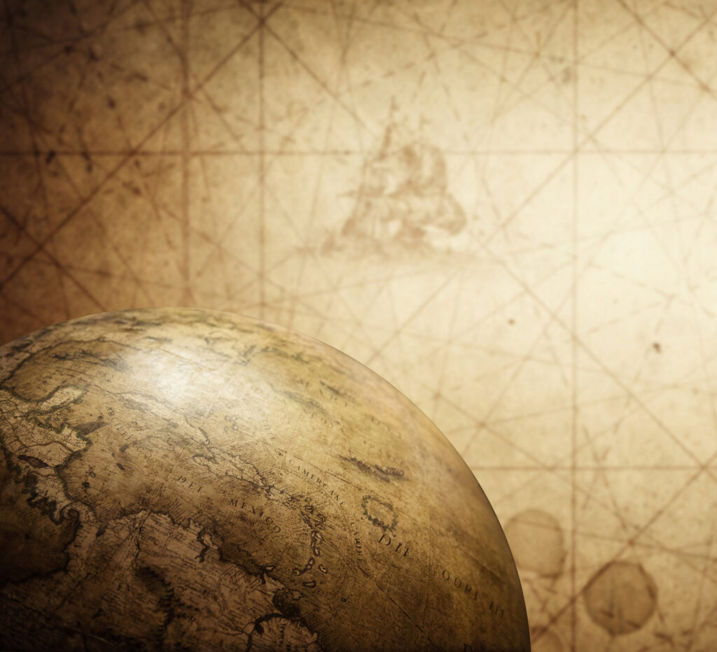 Ancient old globe on the vintage map background. Selective focus. Retro style. Science, education, travel, vintage background. History and geography team.